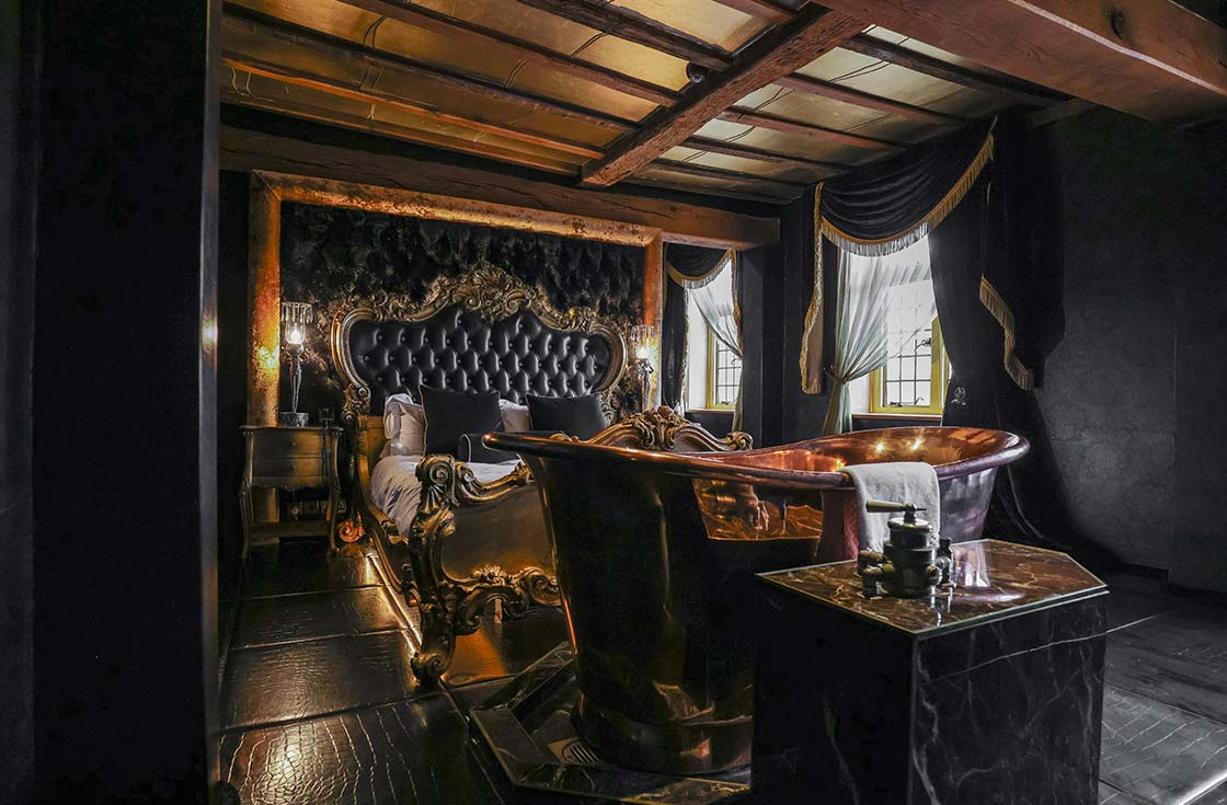Black and Gold Decadent Bedroom with bath at Crazy Bear Beaconsfield