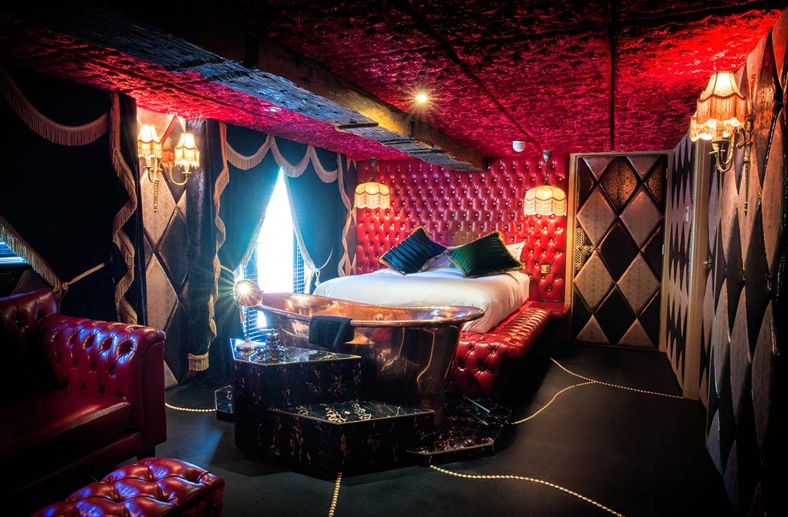Decadent Bedroom with bath filling from ceiling and lounge at Crazy Bear Beaconsfield with Fake kitchen