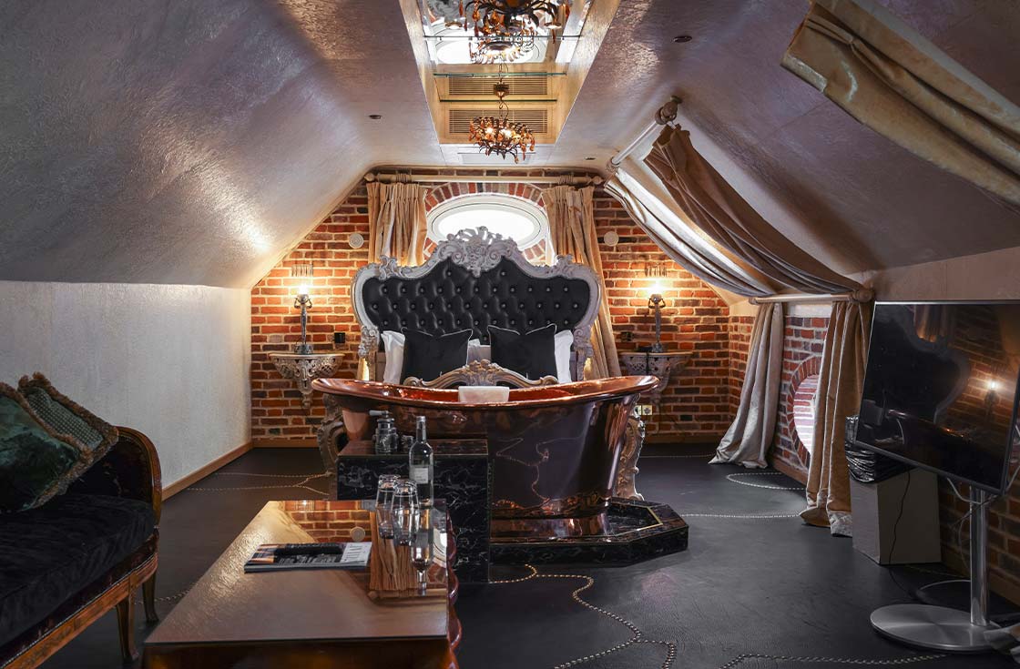 Decadent Bedroom with bath and lounge at Crazy Bear Beaconsfield