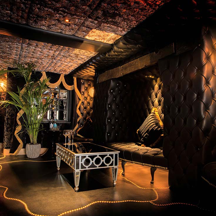 Decadent Bedroom with bath filling from ceiling and lounge at Crazy Bear Beaconsfield